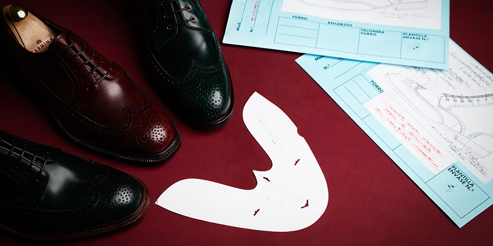 Wingtip shoes and a wingtip pattern piece at Carmina Shoemaker